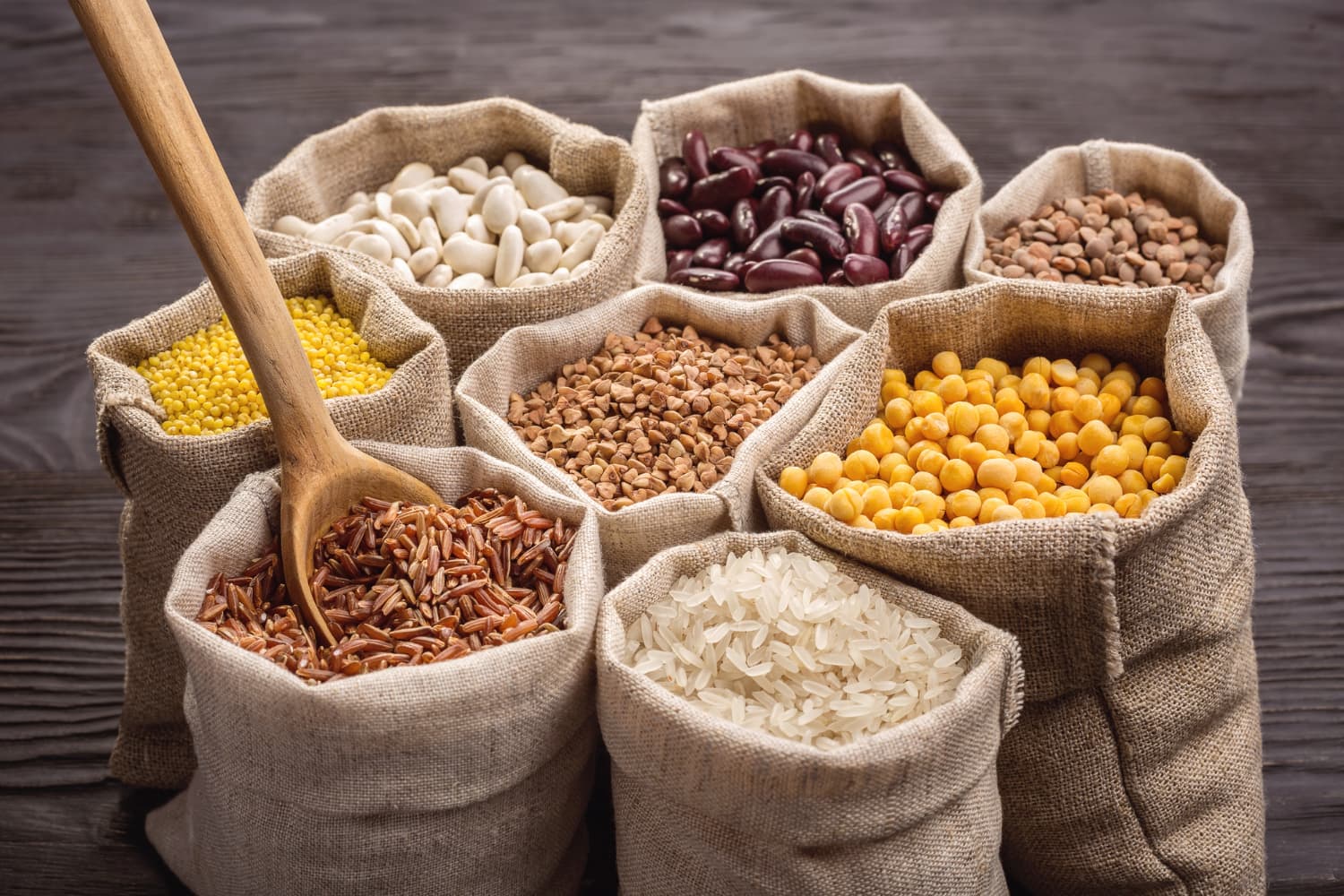 Sacks of bulk rice, corn, wheat, and flour stacked in a warehouse ready for container loading