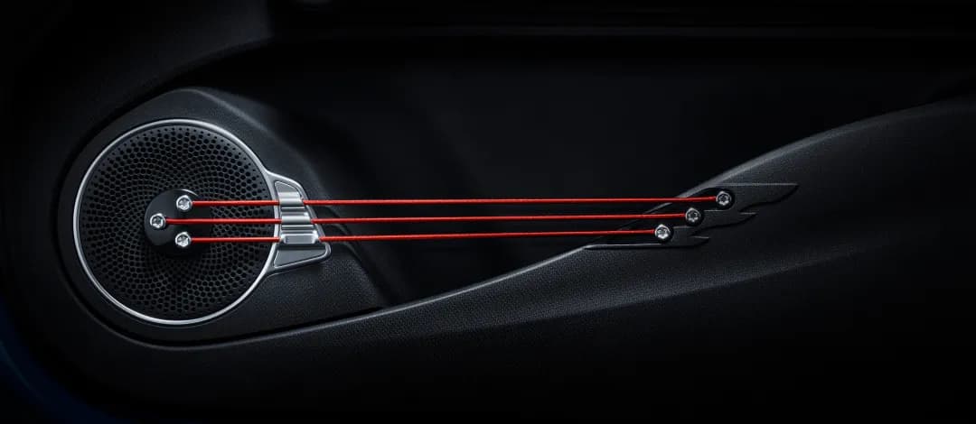 BYD ATTO 3 door panel — guitar-style elastic strings and speaker detail